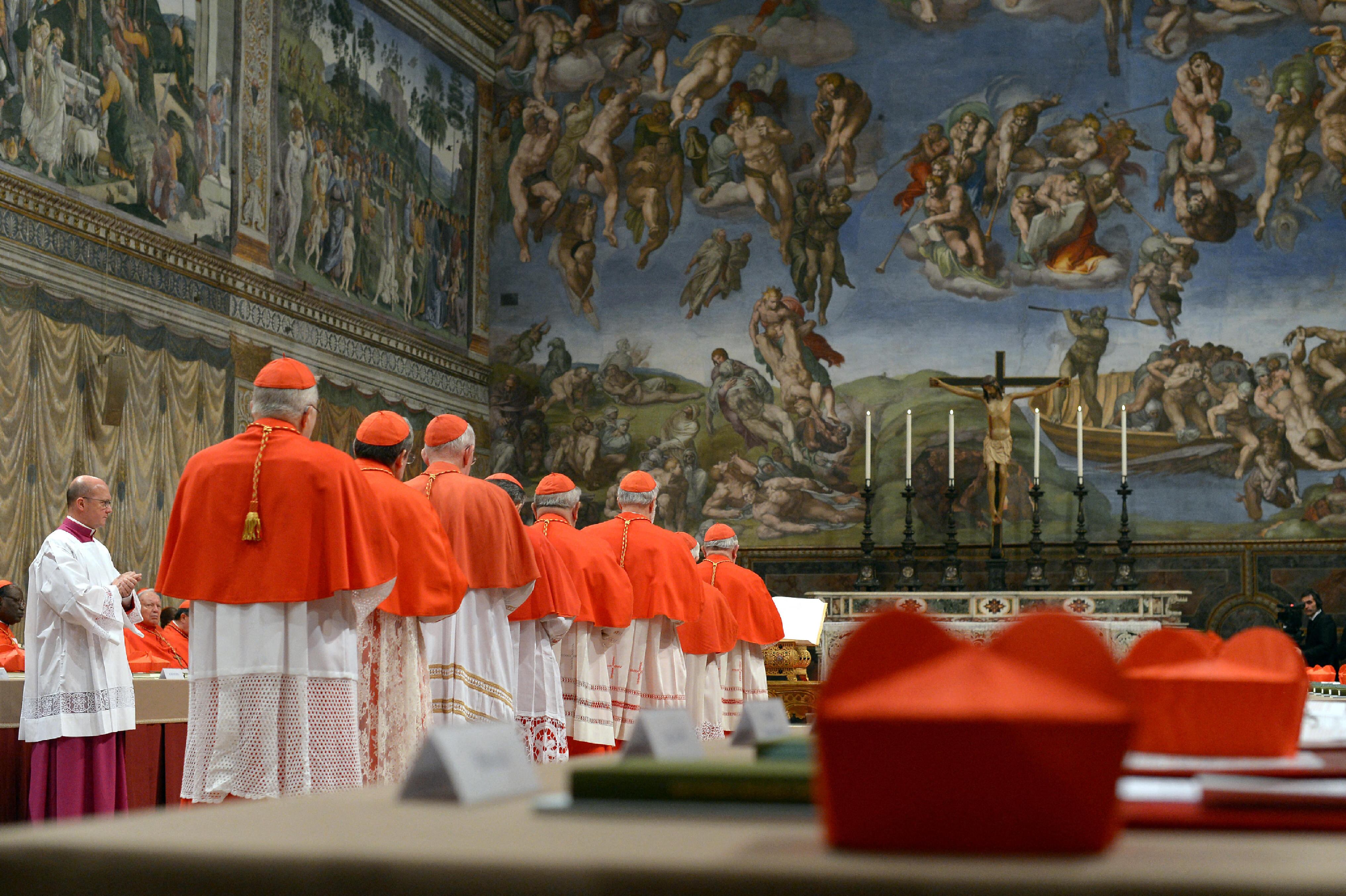 (FILES) This handout picture released by the Press office shows cardinals queuing in the Sistine Chapel to swear on the Bible to never reveal the secrets of their deliberations before the start of the conclave at the Vatican on March 12, 2013. Catholic cardinals meeting in Rome on April 28, 2025, agreed to begin on May 7, 2025, the conclave to elect a successor to Pope Francis, according to ANSA news agency. On Wednesday May 7, the cardinals will take part in a solemn mass at St Peter's Basilica in the Vatican, after which those eligible to vote will gather in the Sistine Chapel for the secretive ballot, which can last several days. (Photo by Handout / OSSERVATORE ROMANO / AFP) / RESTRICTED TO EDITORIAL USE - MANDATORY CREDIT "AFP PHOTO / OSSERVATORE ROMANO" - HANDOUT - NO MARKETING NO ADVERTISING CAMPAIGNS - DISTRIBUTED AS A SERVICE TO CLIENTS