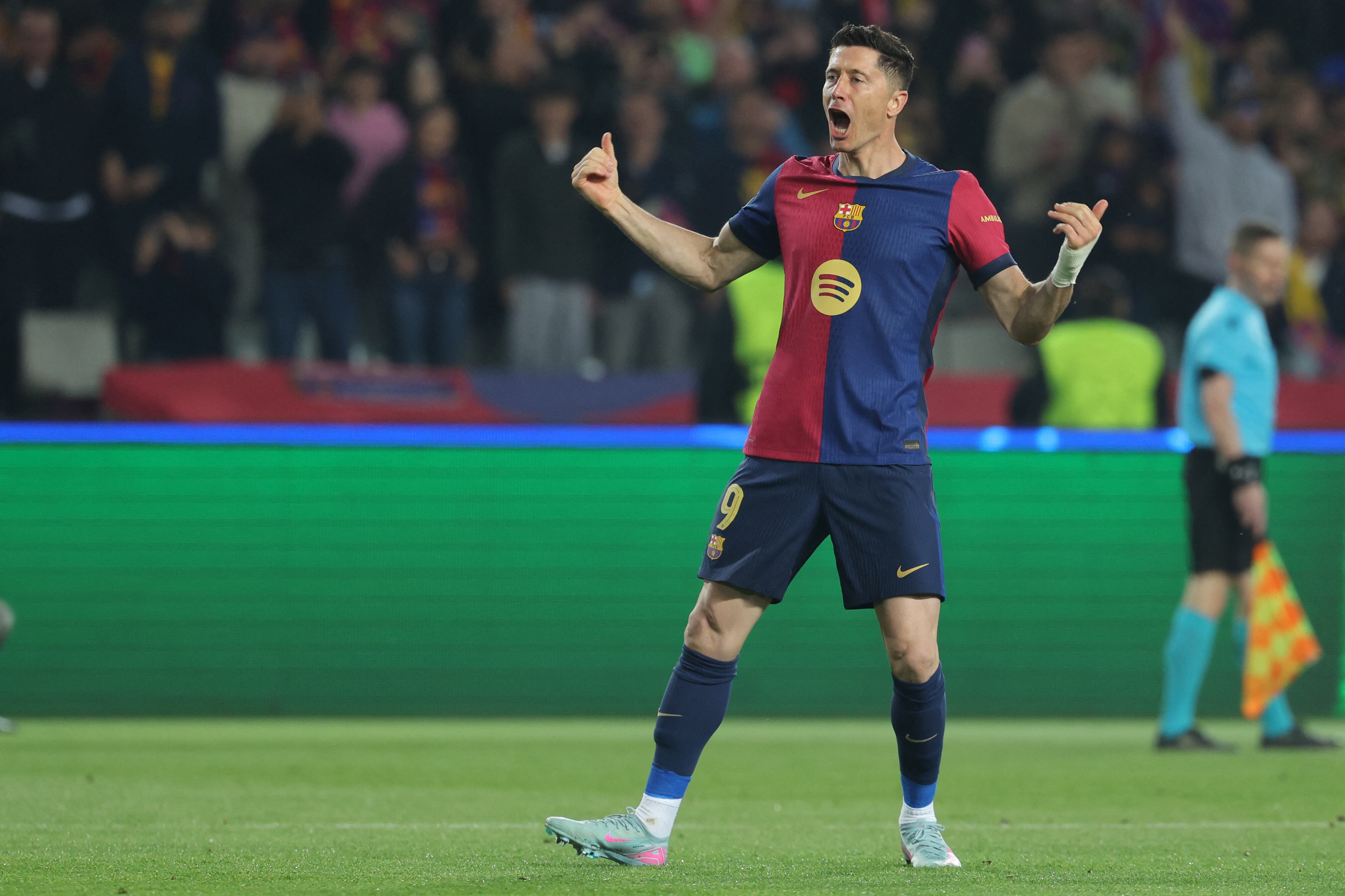 Barcelona's Polish forward #09 Robert Lewandowski celebrates scoring his team's second goal during the UEFA Champions League Quarter final First Leg football match between FC Barcelona and BVB Borussia Dortmund at the Estadi Olimpic Lluis Companys in Barcelona on April 9, 2025. (Photo by LLUIS GENE / AFP)