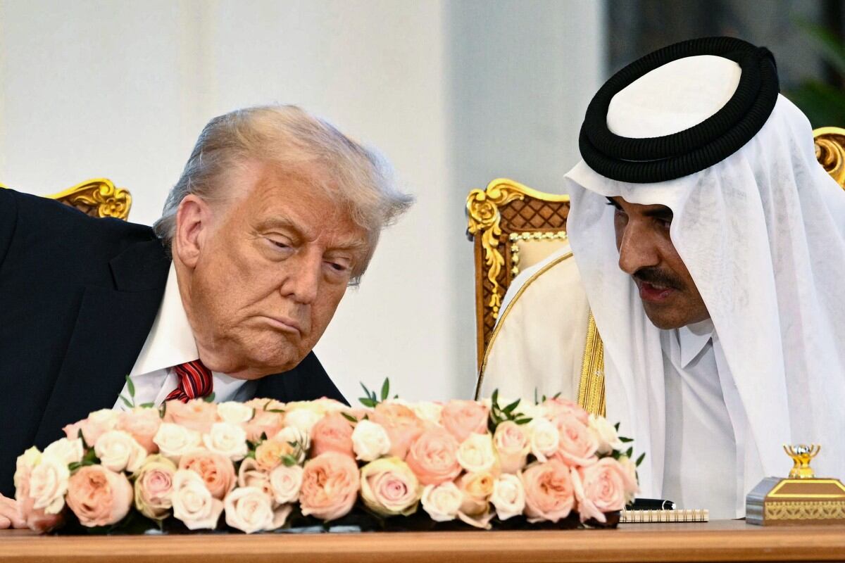 Qatar's Emir Sheikh Tamim bin Hamad al-Thani (R) and US President Donald Trump sit side by side at the Royal Palace in Doha on May 14, 2025. Trump touched down at Hamad International Airport in Doha, with relations between the two governments in the spotlight over Qatar's offer to Trump of a $400 million luxury aircraft to serve as a new Air Force One and then pass into his personal use. (Photo by Brendan SMIALOWSKI / AFP)
