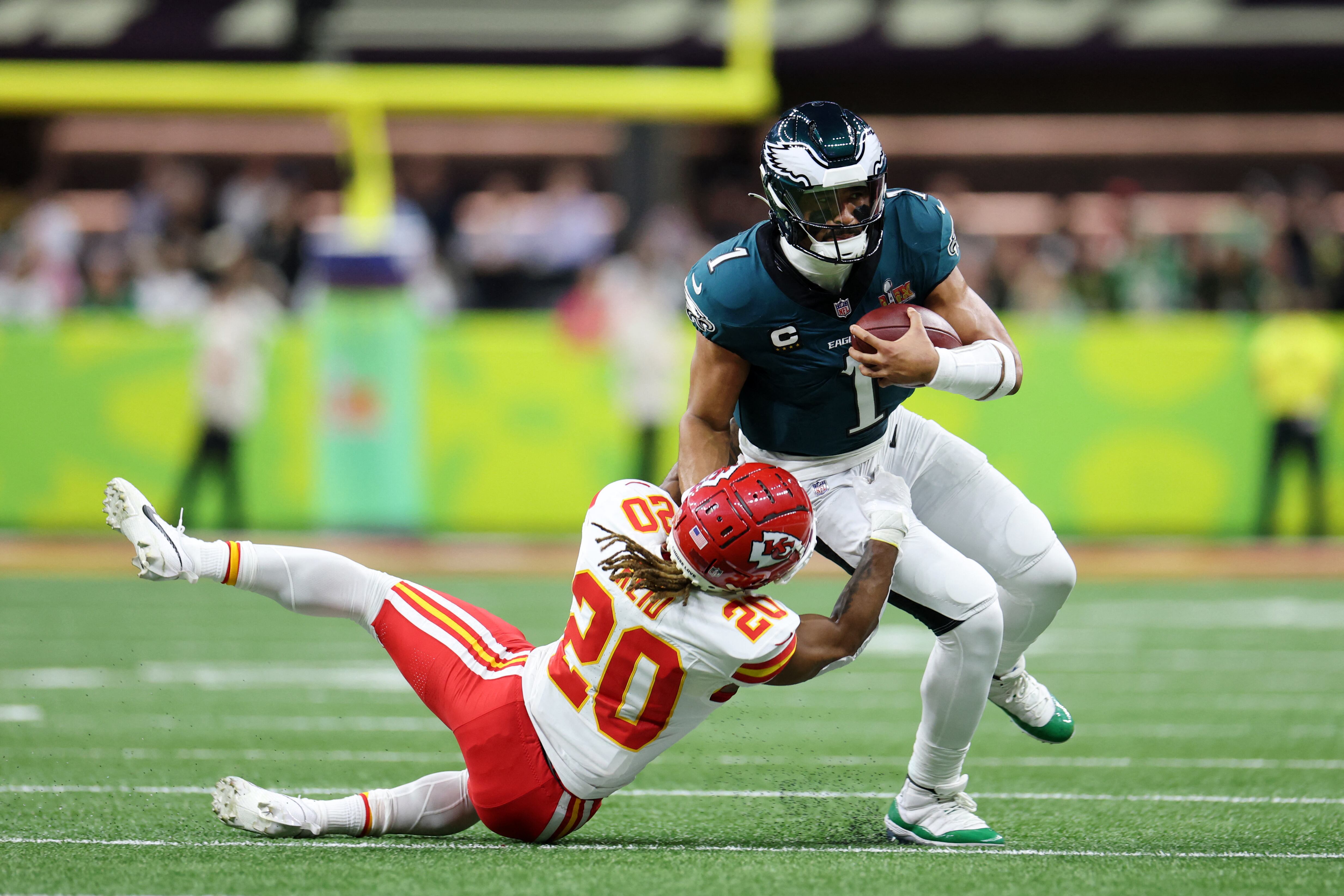 NEW ORLEANS, LOUISIANA - FEBRUARY 09: Jalen Hurts #1 of the Philadelphia Eagles tackles Justin Reid #20 of the Kansas City Chiefs in the second quarter during Super Bowl LIX at Caesars Superdome on February 09, 2025 in New Orleans, Louisiana. Jamie Squire/Getty Images/AFP (Photo by JAMIE SQUIRE / GETTY IMAGES NORTH AMERICA / Getty Images via AFP)