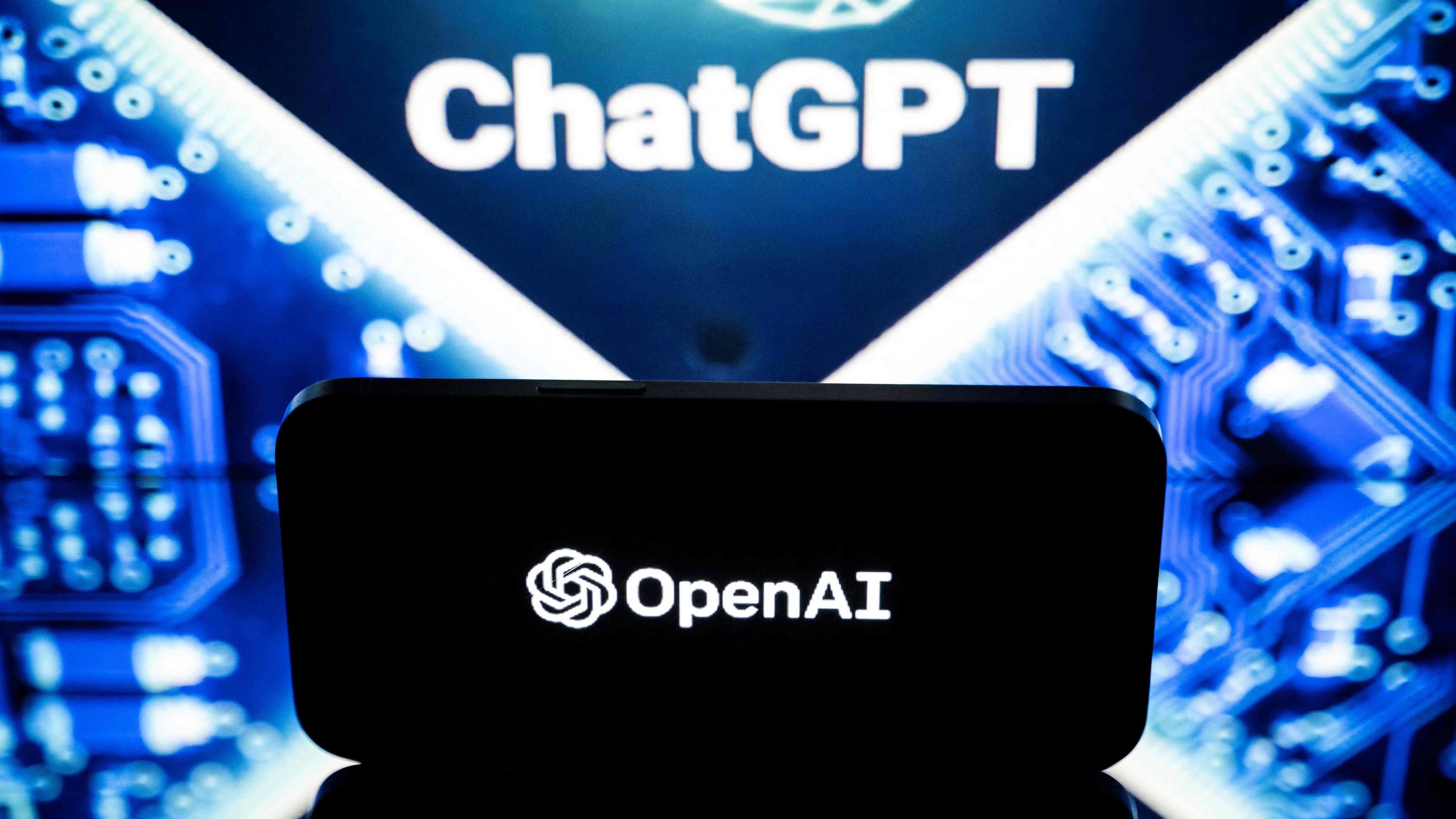This picture taken on January 23, 2023 in Toulouse, southwestern France, shows screens displaying the logos of OpenAI and ChatGPT. - ChatGPT is a conversational artificial intelligence software application developed by OpenAI. (Photo by Lionel BONAVENTURE / AFP)