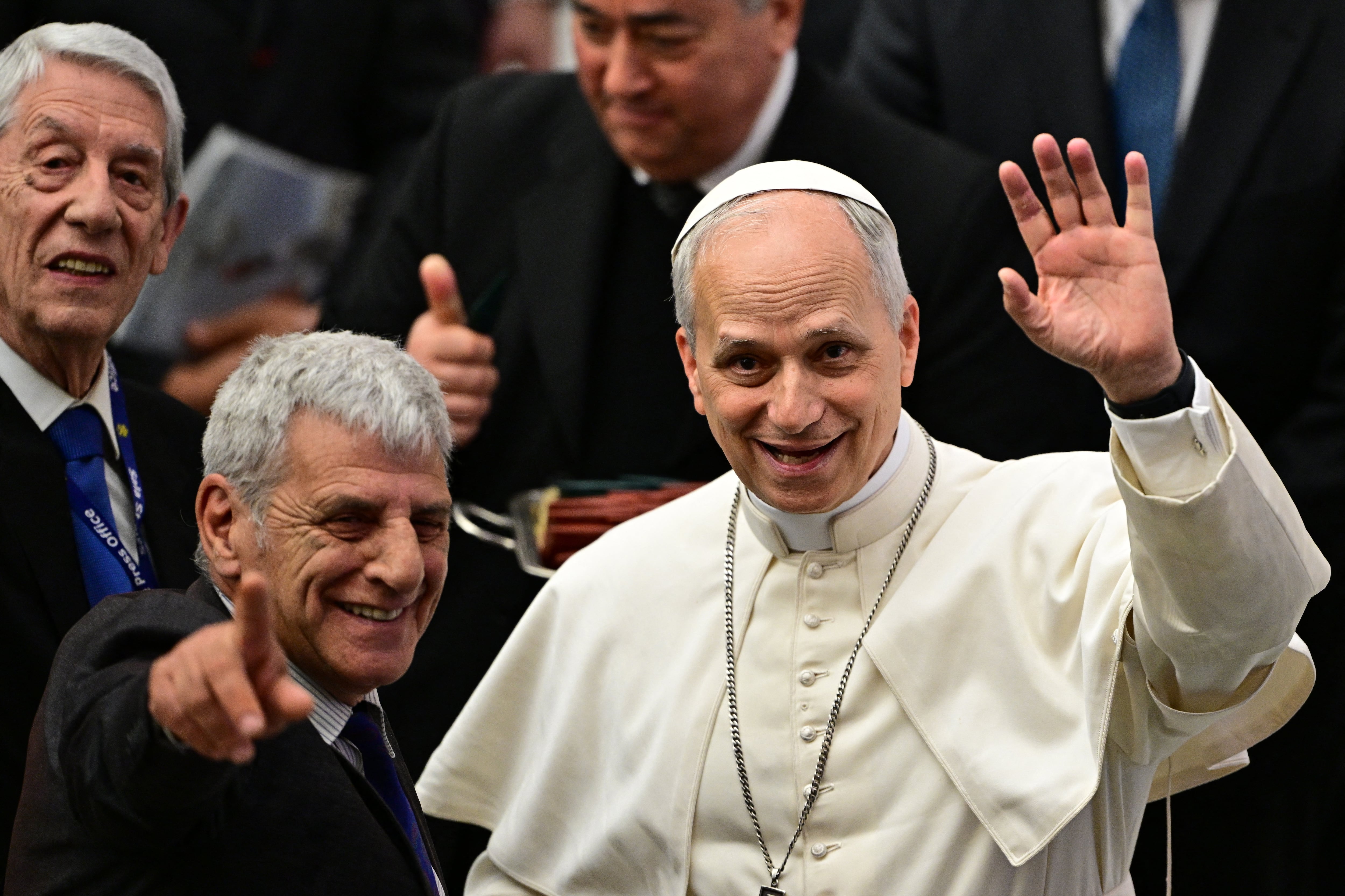 Pope Leo XIV (R) gestures during an audience to representatives of the media, at Paul-VI hall in The Vatican, on May 12, 2025. (Photo by Tiziana FABI / AFP)