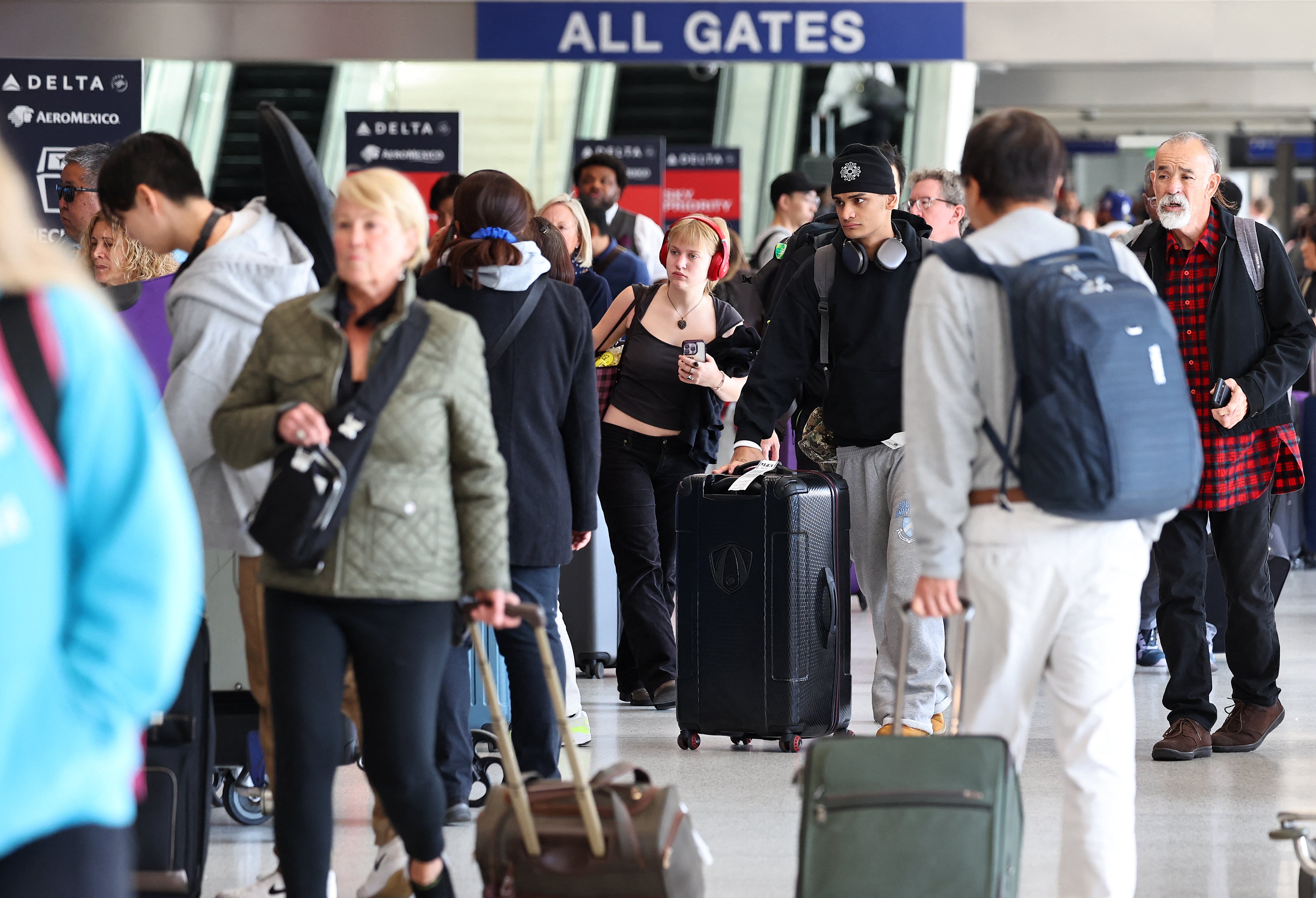 LOS ANGELES, CALIFORNIA - DECEMBER 02: Travelers gather with their luggage in the Delta terminal at Los Angeles International Airport (LAX) following the Thanksgiving holiday on December 2, 2024 in Los Angeles, California. According to the Transportation Security Administration (TSA), Thanksgiving Sunday was the busiest day for commercial airline travel ever, with preliminary numbers indicating more than 3 million travelers were screened in U.S. airports yesterday with many people still making their way home today. Mario Tama/Getty Images/AFP (Photo by MARIO TAMA / GETTY IMAGES NORTH AMERICA / Getty Images via AFP)
