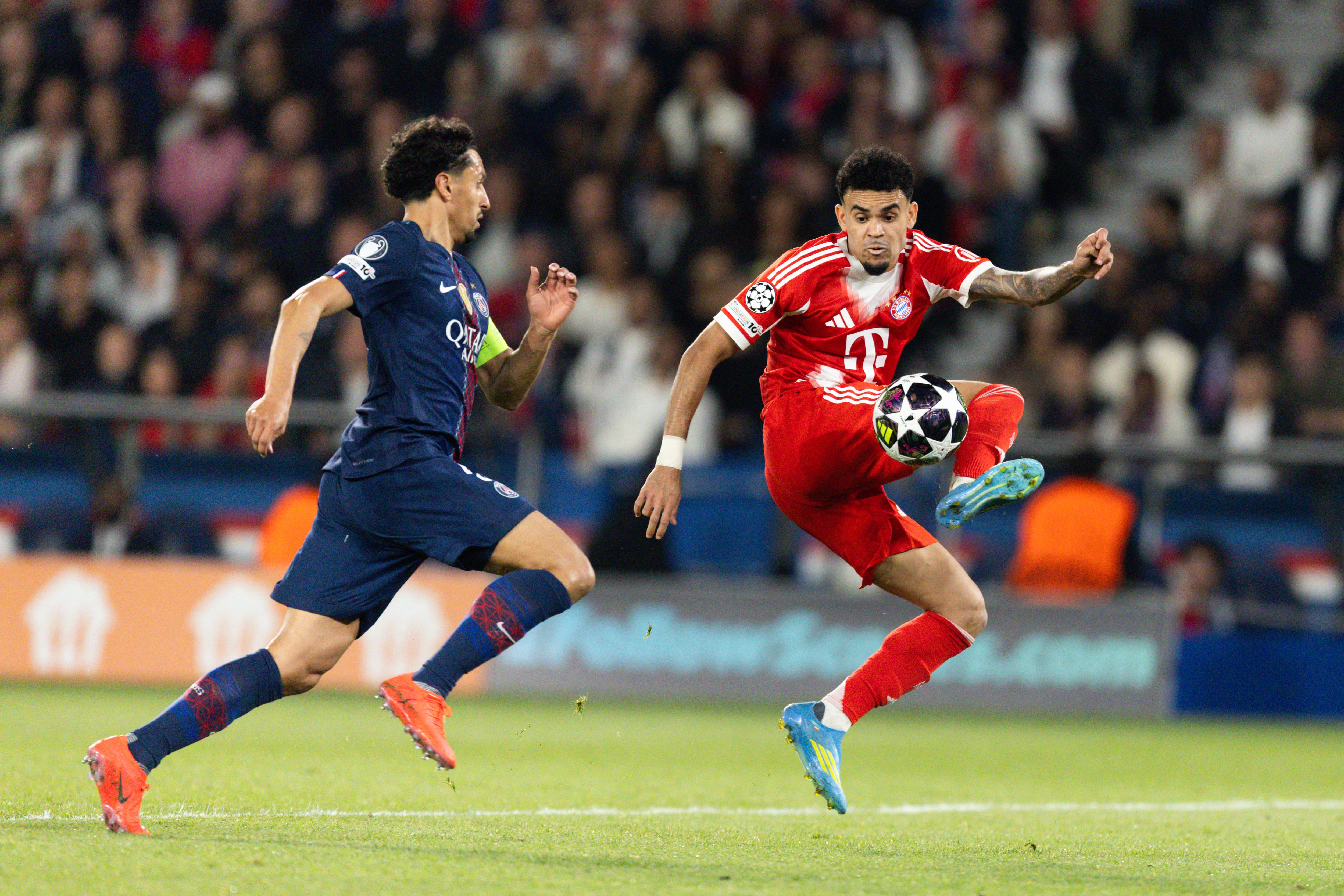 Marquinhos of Paris Saint-Germain (L) and Luis Diaz of Bayern Munich (R) compete during the UEFA Champions League semi-final first leg football match between Paris Saint-Germain and Bayern Munich at the Parc des Princes. (Photo by Ibrahim Ezzat/NurPhoto) (Photo by Ibrahim Ezzat / NurPhoto via AFP)