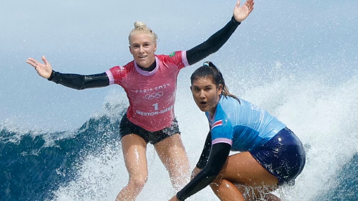 TEAHUPO'O, FRENCH POLYNESIA - AUGUST 5: Tatiana Weston-Webb (L) of Brazil reacts as Brisa Hennessy of Costa Rica drops in on her in the women's surfing semi-finals of the Paris 2024 Olympic Games August 5, 2024 in Teahupo'o, on the French Polynesian Island of Tahiti.  (Photo by  Ben Thouard-Pool/Getty Images)