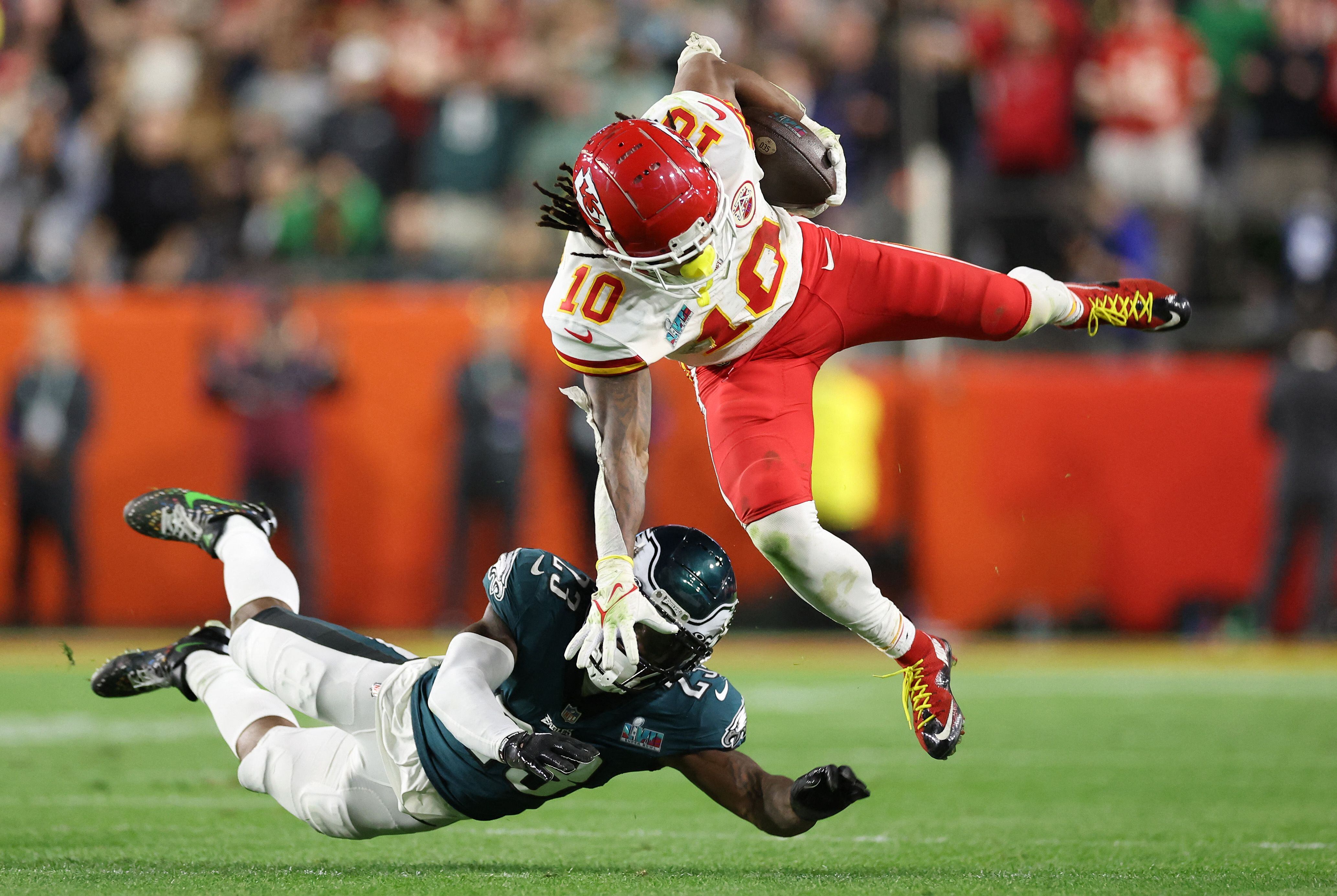Foto de un partido entre Kansas City Chiefs y Philadelphia Eagles. Dos jugadores en el aire cayendo.