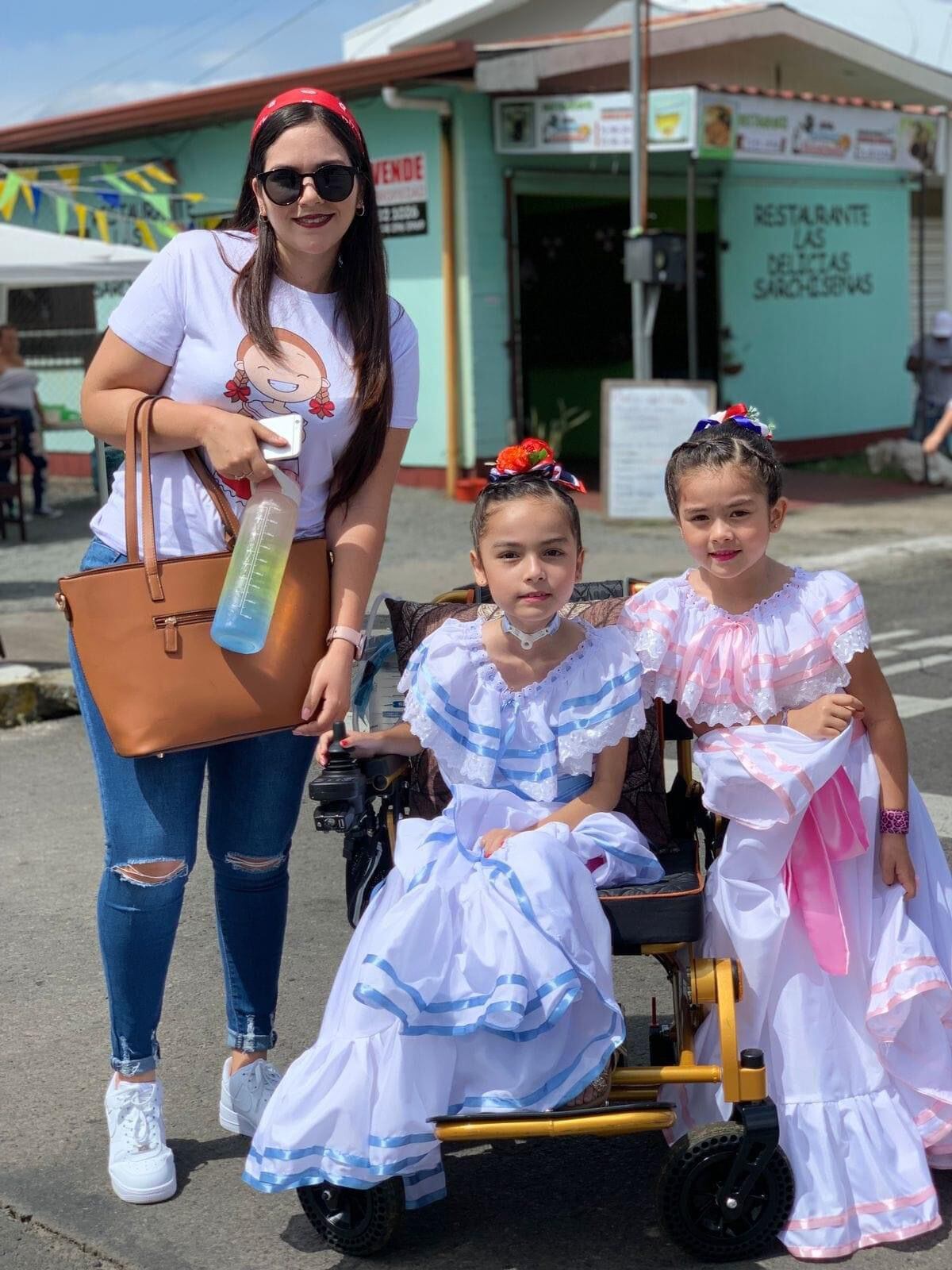 Ebonny Ballestero Rodríguez es una niña de 9 años que baila típico, pinta uñas, ama el maquilla y pinta cuadros, demostrando que utilizar una silla de ruedas no es obstáculo para alcanzar los sueños. En la foto con doña Yoseth Ballestero, la mamá y la hermanita, Adison.