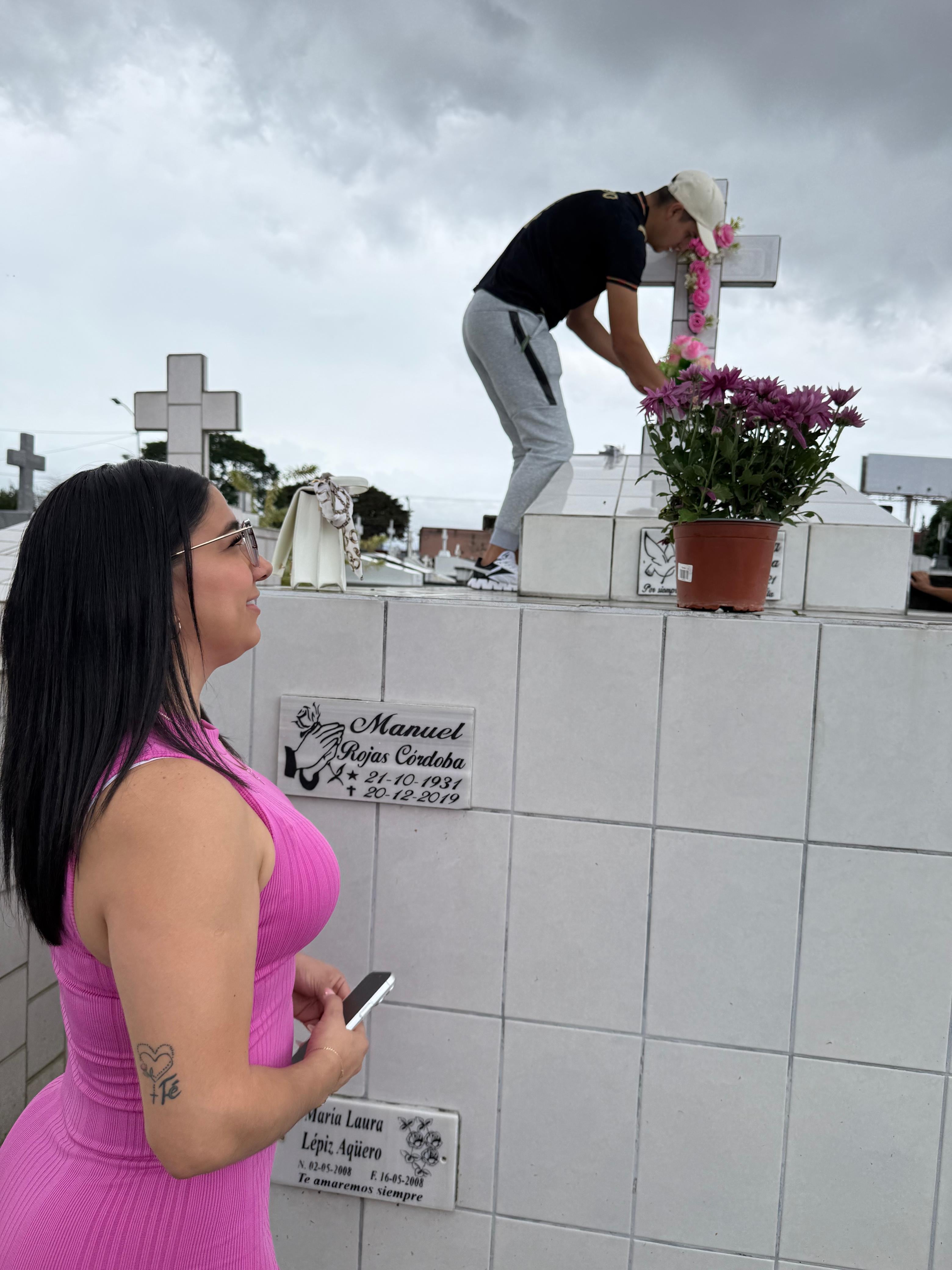 El sábado 15 de agosto del 2026, Día de las Madres, realizamos un recorrido por tres cementerios en San José: el Obreros, el General y el Municipal de Desamparados. En la foto, Mari Cruz Agüero observa como Nelson Mejías adorna la tumba de su hija, María Laura Lepiz.