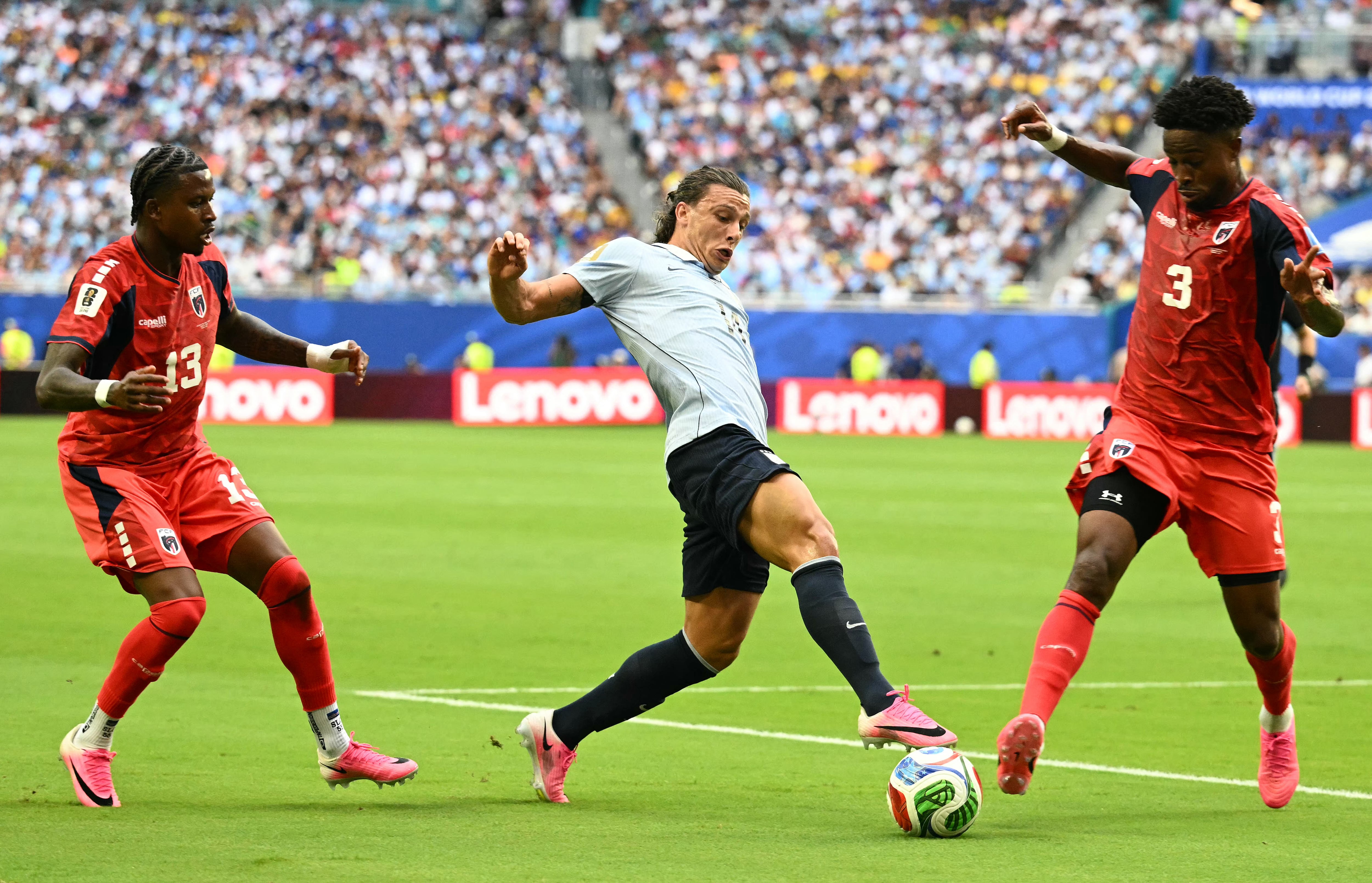 Uruguay's forward #14 Agustin Canobbio, Cape Verde's defender #13 Sidney Lopes Cabral and Cape Verde's defender #03 Diney Borges fight for the ball during the 2026 World Cup Group H football match between Uruguay and Cape Verde at the Miami Stadium in Miami Gardens on June 21, 2026. (Photo by CHANDAN KHANNA / AFP)