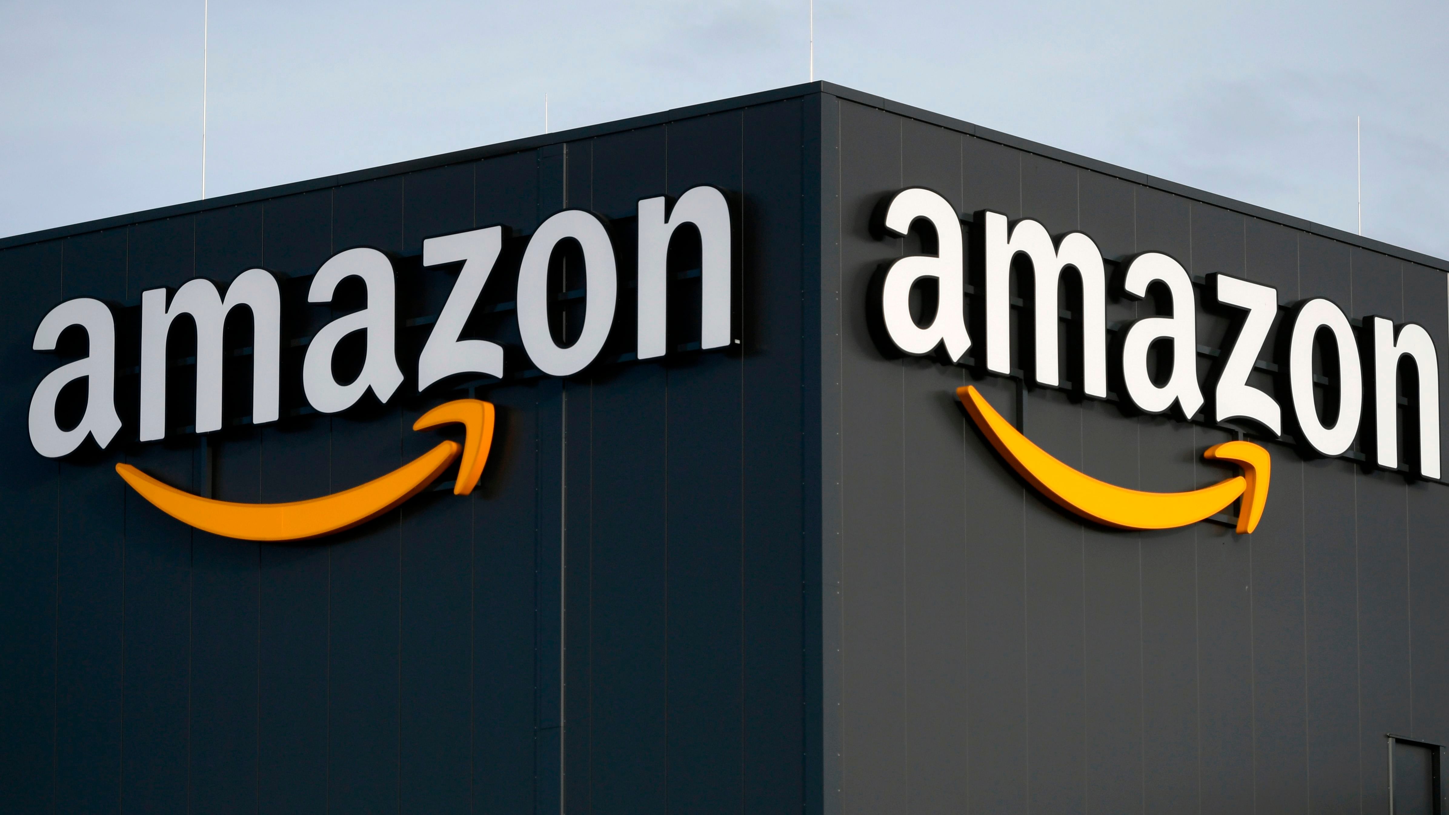 (FILES) This file picture shows the logo of US online retail giant Amazon at the distribution center in Moenchengladbach, western Germany, on December 17, 2019. - Amazon confirmed Tuesday that an employee who works in the internet giant's home city of Seattle had been quarantined after testing positive for the new coronavirus. (Photo by INA FASSBENDER / AFP)