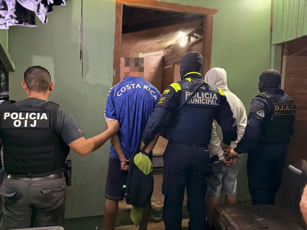 Agentes del OIJ custodiaron a los dos sujetos detenidos durante el allanamiento realizado la mañana de este jueves en el sector de La Tesalia, en Ciudad Quesada, como parte de una investigación judicial.