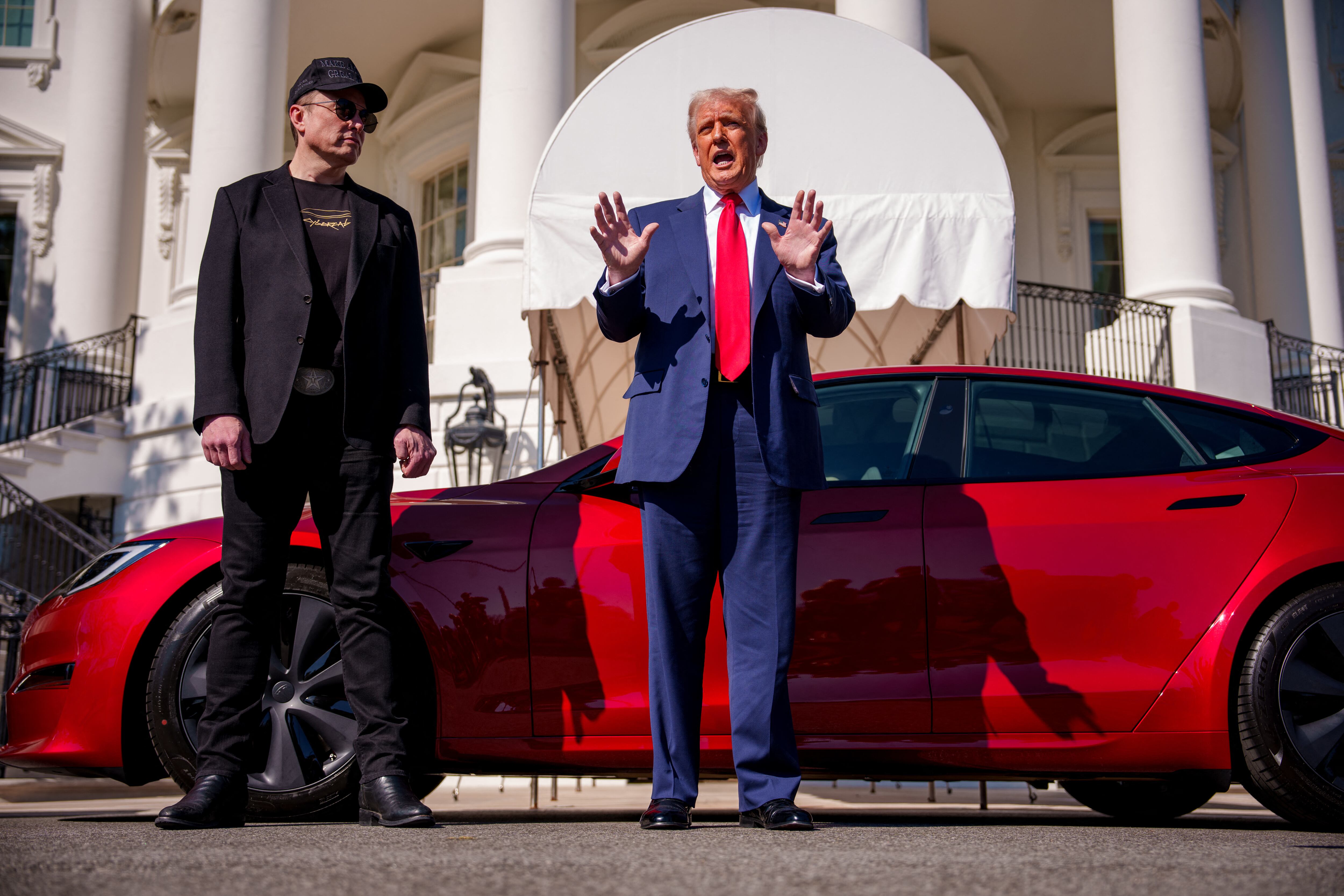 WASHINGTON, DC - MARCH 11: U.S. President Donald Trump, accompanied by White House Senior Advisor, Tesla and SpaceX CEO Elon Musk, speaks next to a Tesla Model S on the South Lawn of the White Ho
