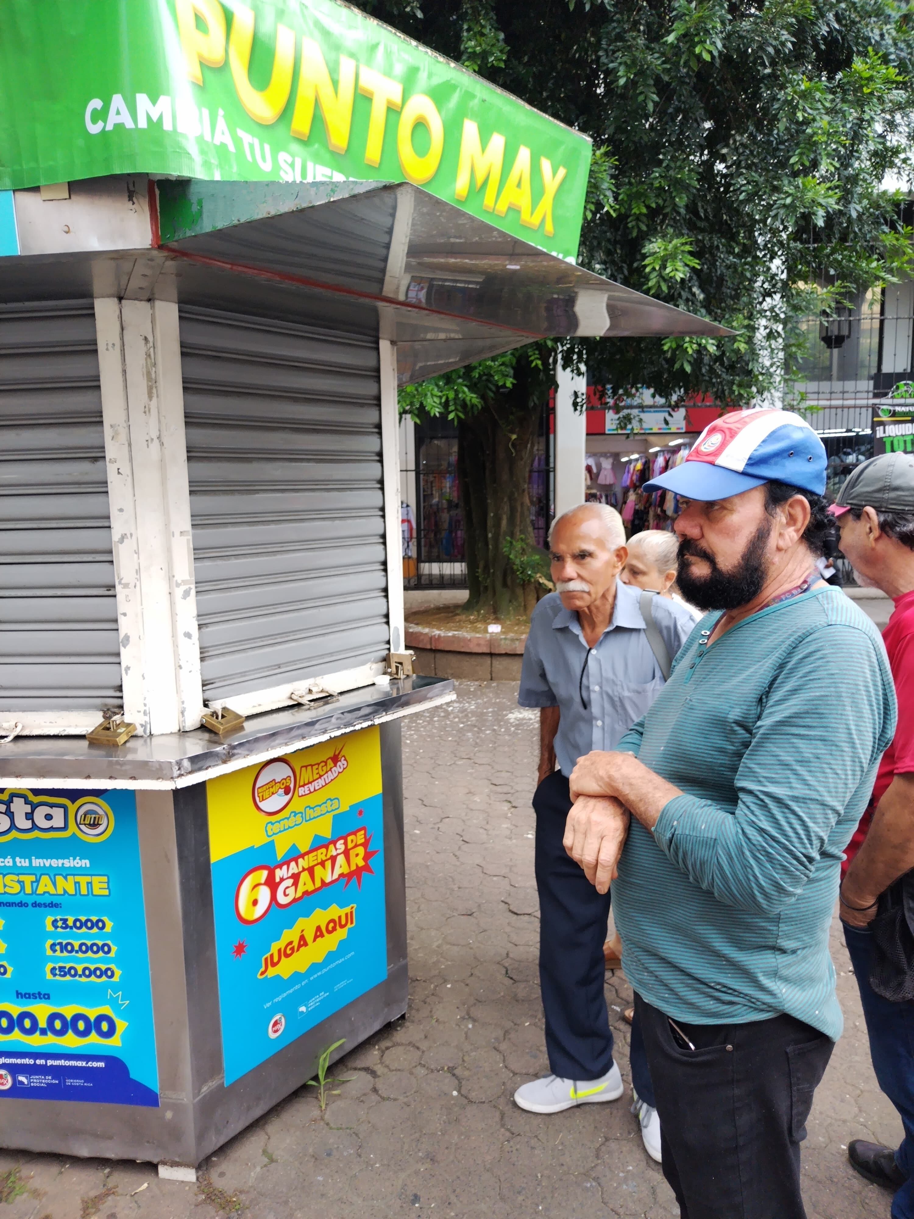El sobreprecio se convirtió en el rey en San José entre los que estaban vendiendo lotería porque un pedacito de mil colones llegó a ser vendido hasta el 5 rojos. En la foto, William Durán, de San José, llegó a las 7 de la mañana al Punto Max que está al costado oeste del bulevar del edificio de Correos de Costa Rica, tenía la fe de que abrieran y así comprar el 82