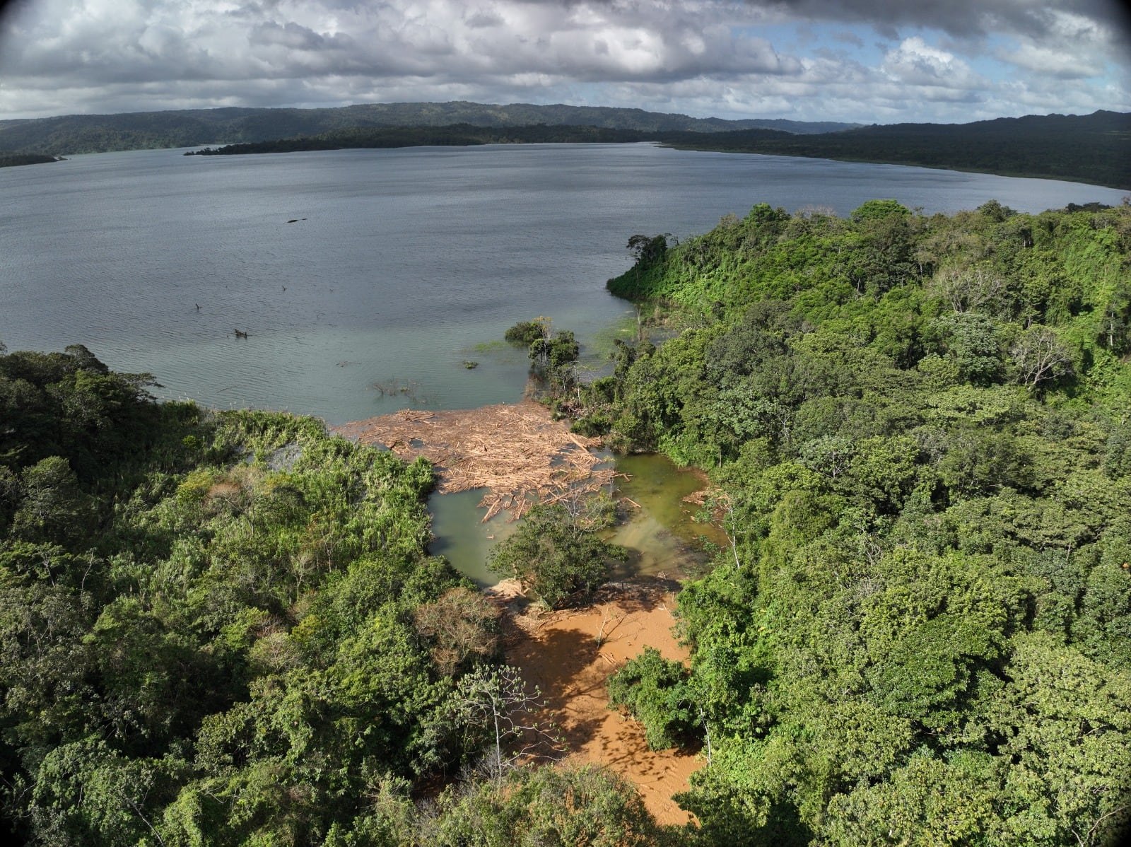 El material que bajó de la montaña fue a dar a la lago Arenal. Todavía este jueves se observaban troncos y barro en la desembocadura del río. Foto: Cortesía CNE.