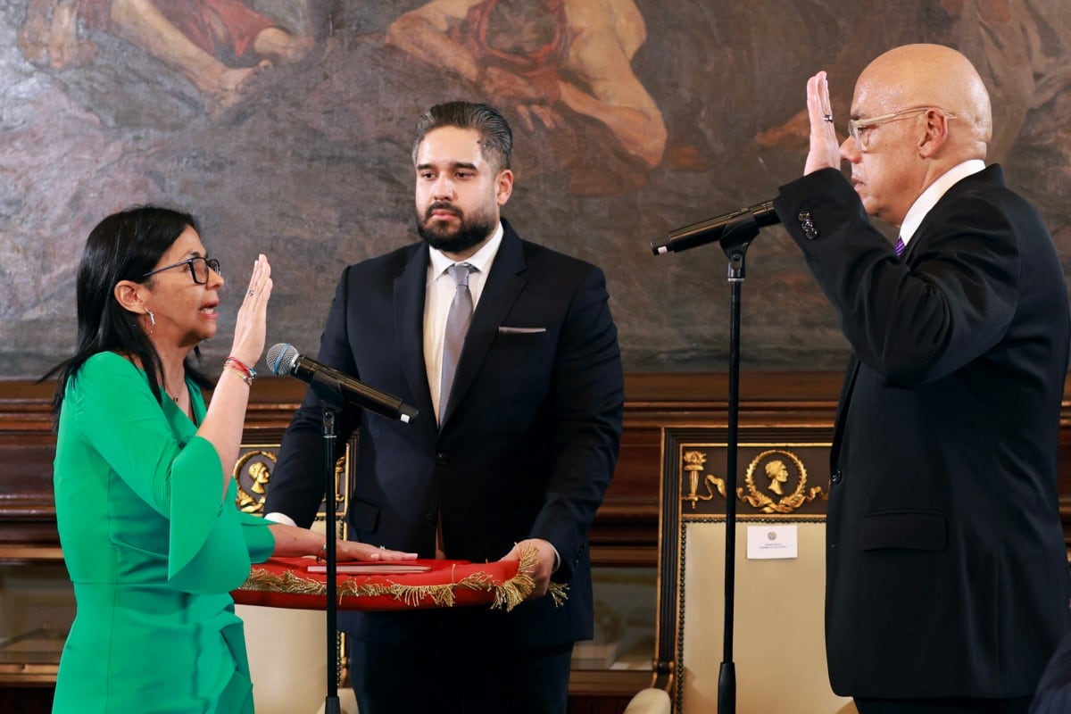 Delcy Rodriguez (L) taking an oath in front of Venezuela's National Assembly President Jorge Rodriguez (R) and Deputy Nicolas Maduro Guerra (C) during a session of the National Assembly in Caracas on January 5, 2026.