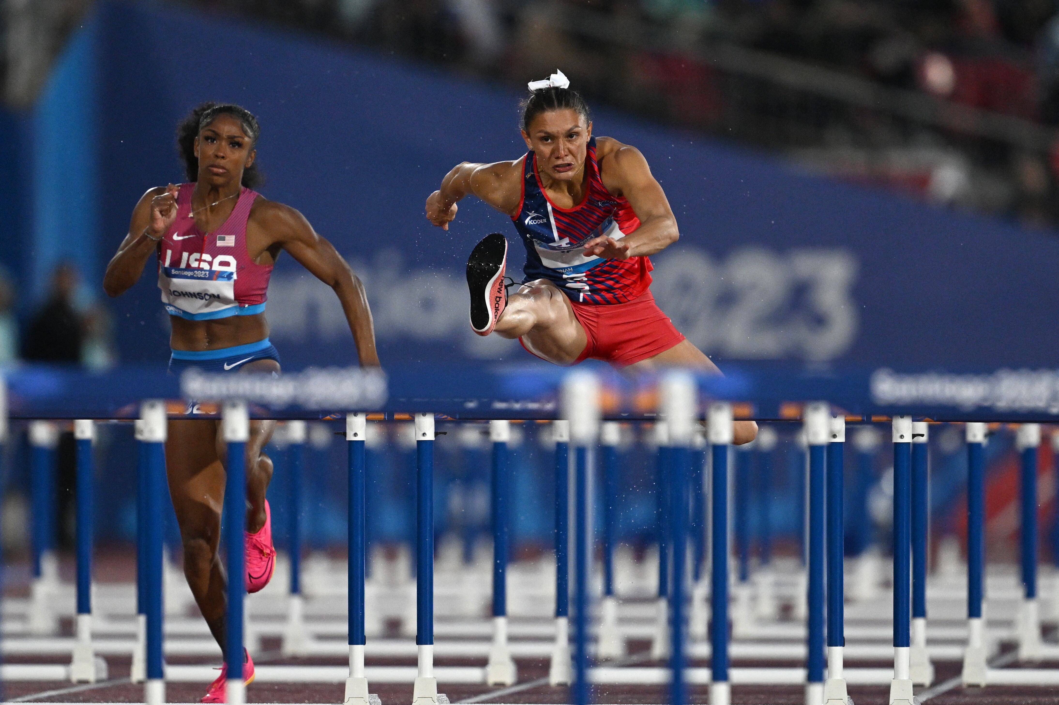 Costa Rica's Andrea Carolina Vargas Mena crosses the line to win the women's 100m hurdles final of the Pan American Games Santiago 2023 at the National Stadium in Santiago, on November 1st, 2023. (Photo by MAURO PIMENTEL / AFP)