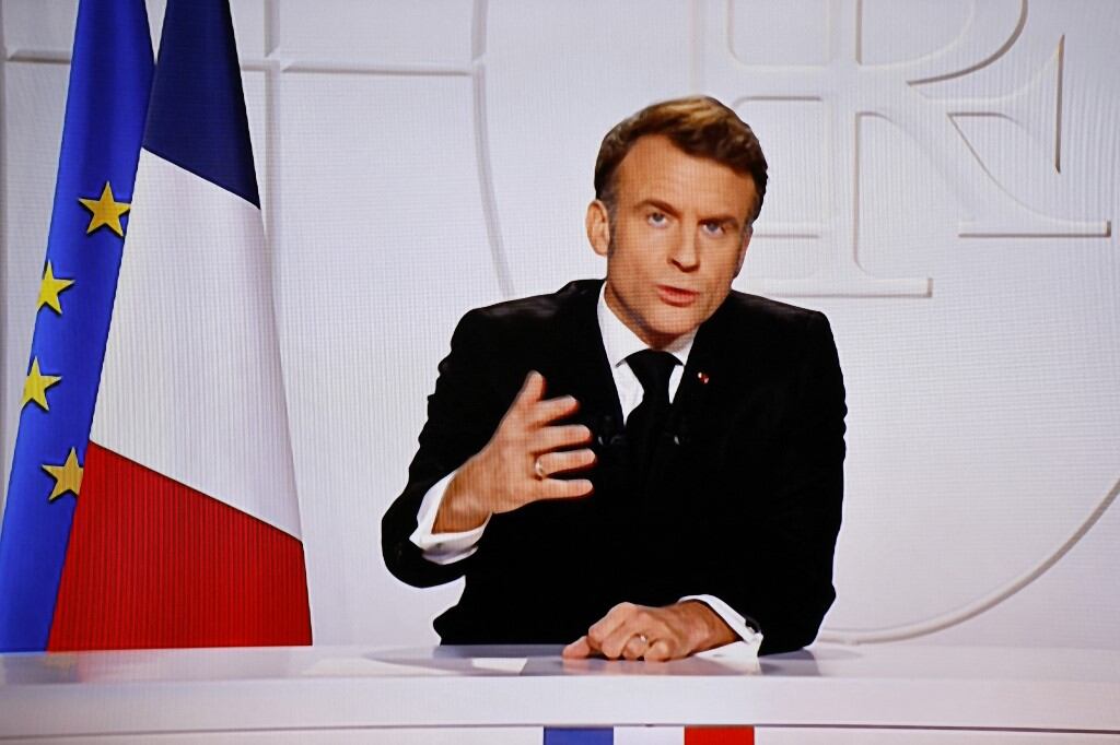 This photograph taken on March 5, 2025, shows a television screen broadcasting France's President Emmanuel Macron addressing a live interview on French TV at the Elysee Presidential Palace in Paris. Emmanuel Macron announced on March 5, 2025, that France will gather next week in Paris the chiefs of staff from countries ready to guarantee a future peace in Ukraine. (Photo by Ludovic MARIN / AFP)