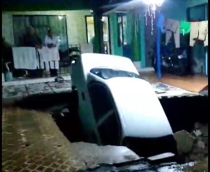 El carro cayó dentro del enorme huevo que se formó en la cochera. Foto Aserrí Última Hora.