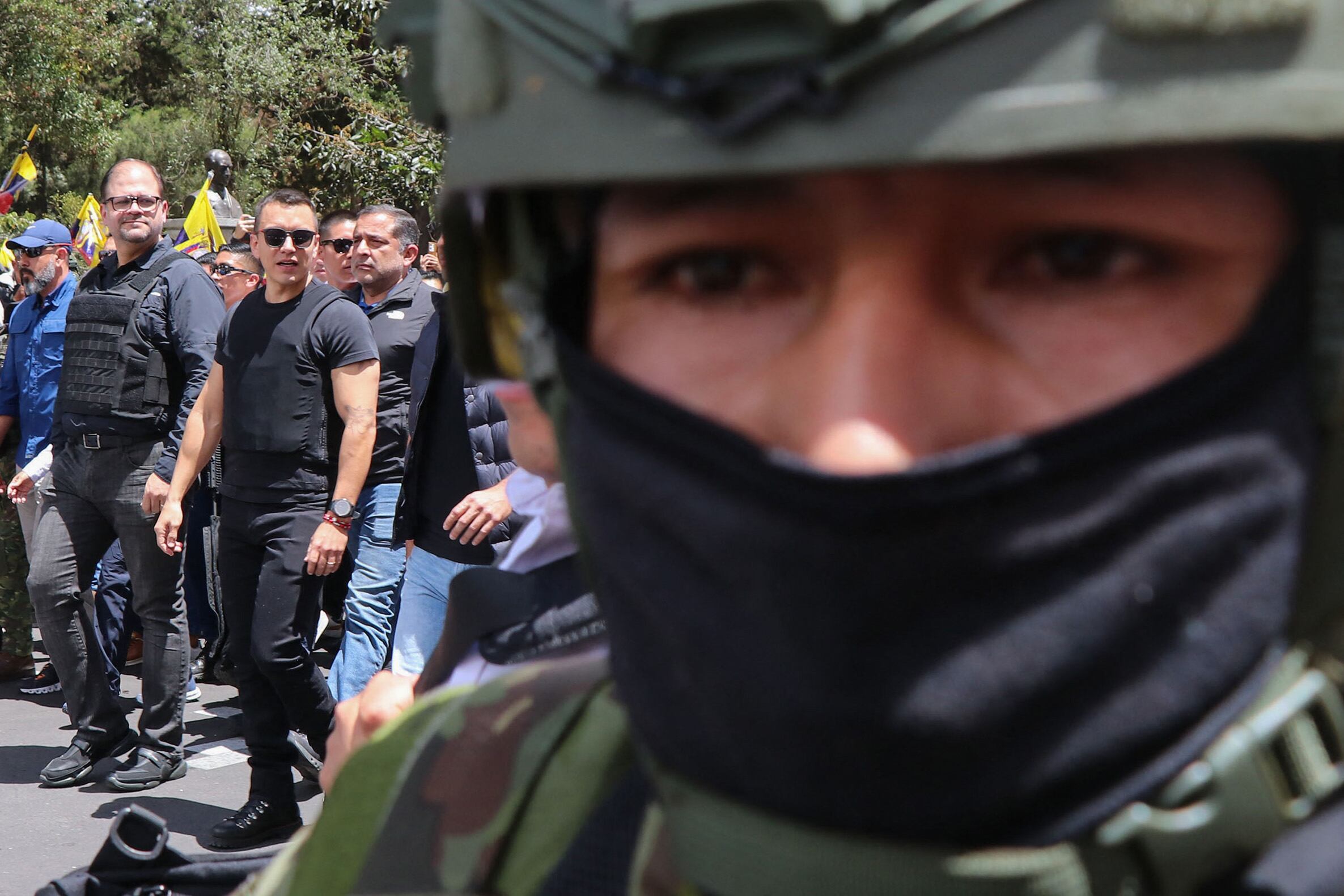 Ecuador's President Daniel Noboa (2nd L) and Interior Minister John Reimberg (L) walk wearing bulletproof vests during a march against the Constitutional Court's decision to censor several articles of recent laws in Quito on August 12, 2025. (Photo by Galo Paguay / AFP)