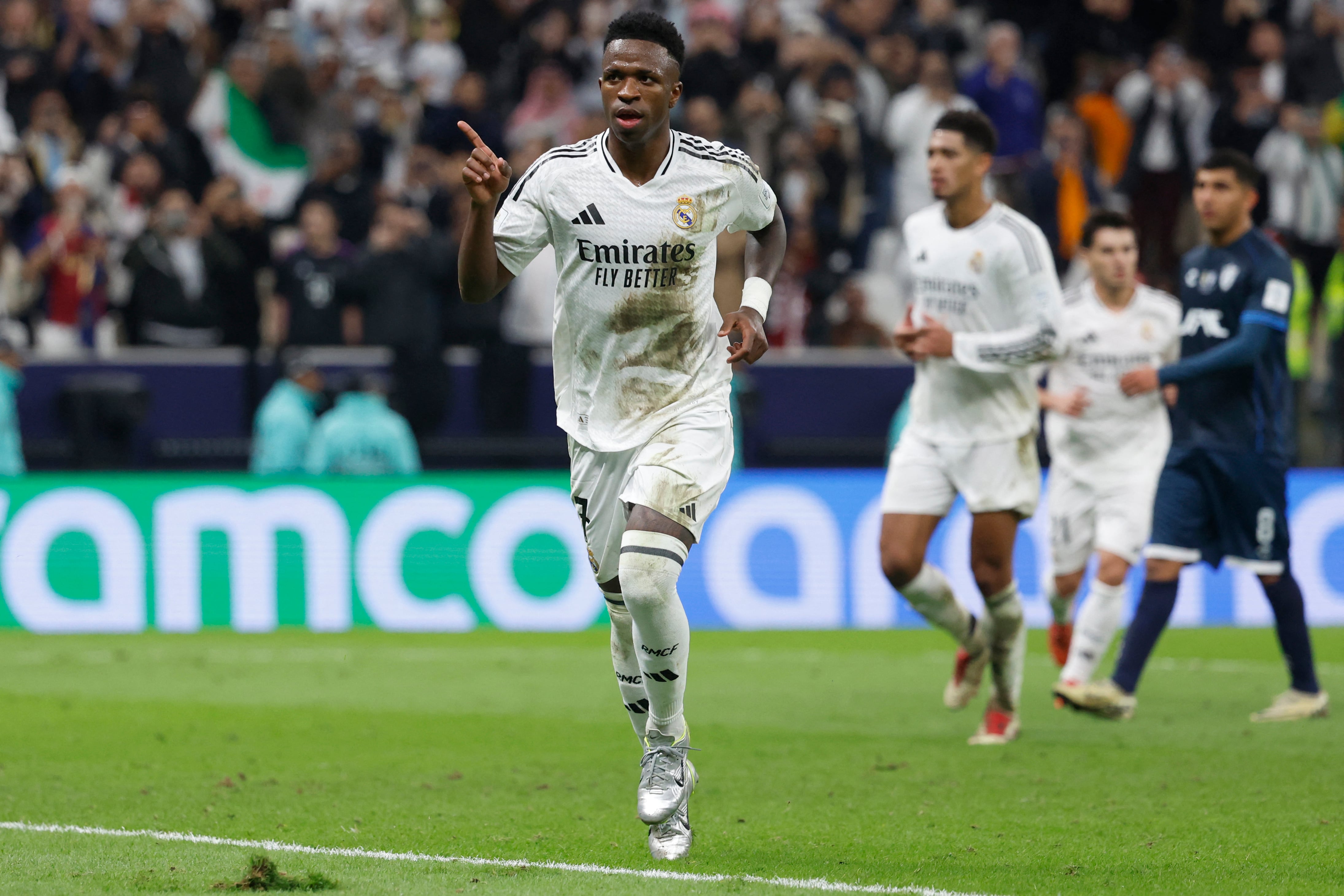 Real Madrid's Brazilian forward #7 Vinicius Junior celebrates after scoring his team's third goal from a penalty kick during the 2024 FIFA Intercontinental Cup final football match between Spain's Real Madrid and Mexico's Pachuca at the Lusail Stadium in Doha on December 18, 2024. (Photo by KARIM JAAFAR / AFP)
