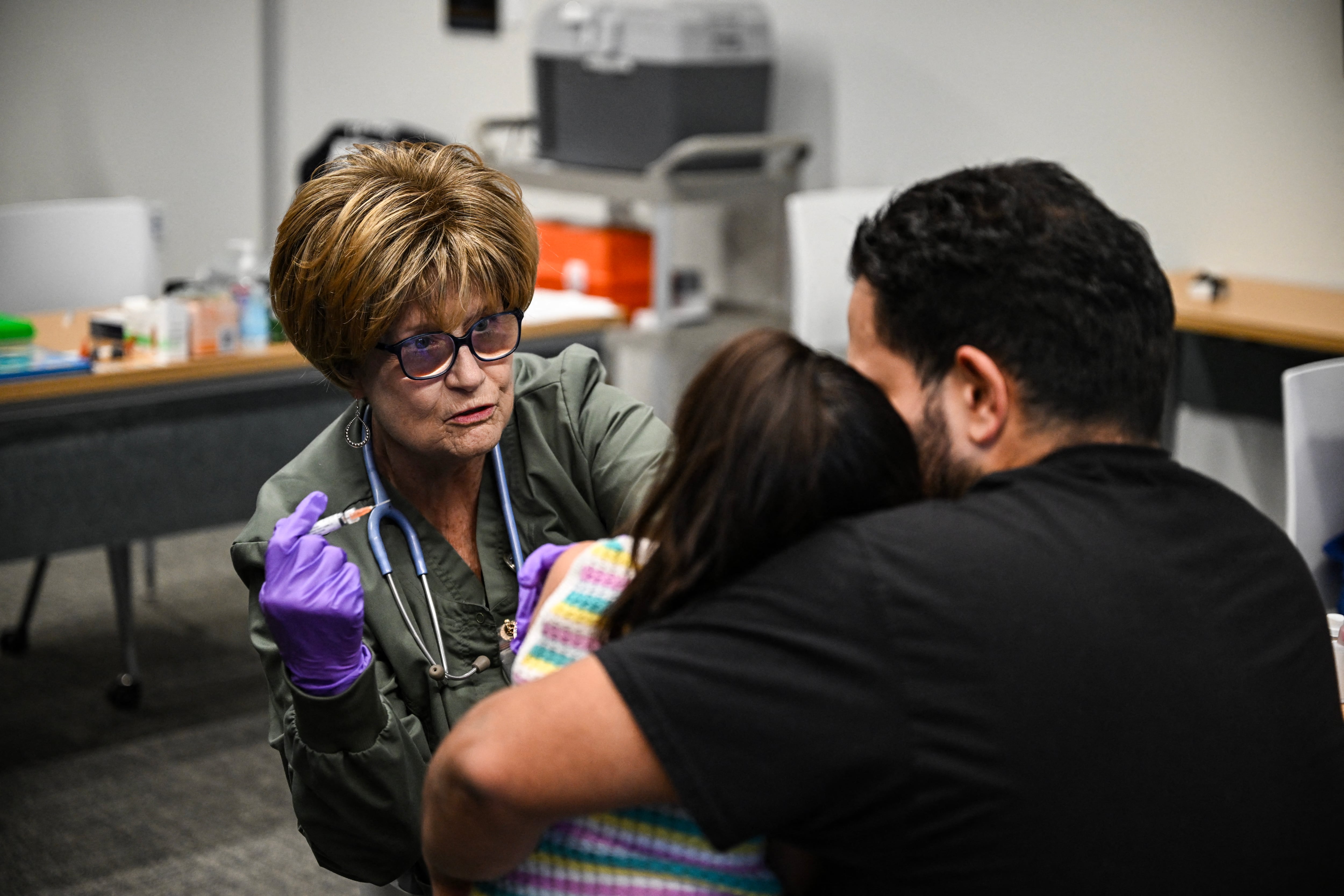 A member of the medical staff administers a dose of the measles vaccine to a child at a health center in Lubbock, Texas, on February 27, 2025. Dozens of children are being rushed to a health center in the US state of Texas to get the measles vaccine, after the recent death in the area o