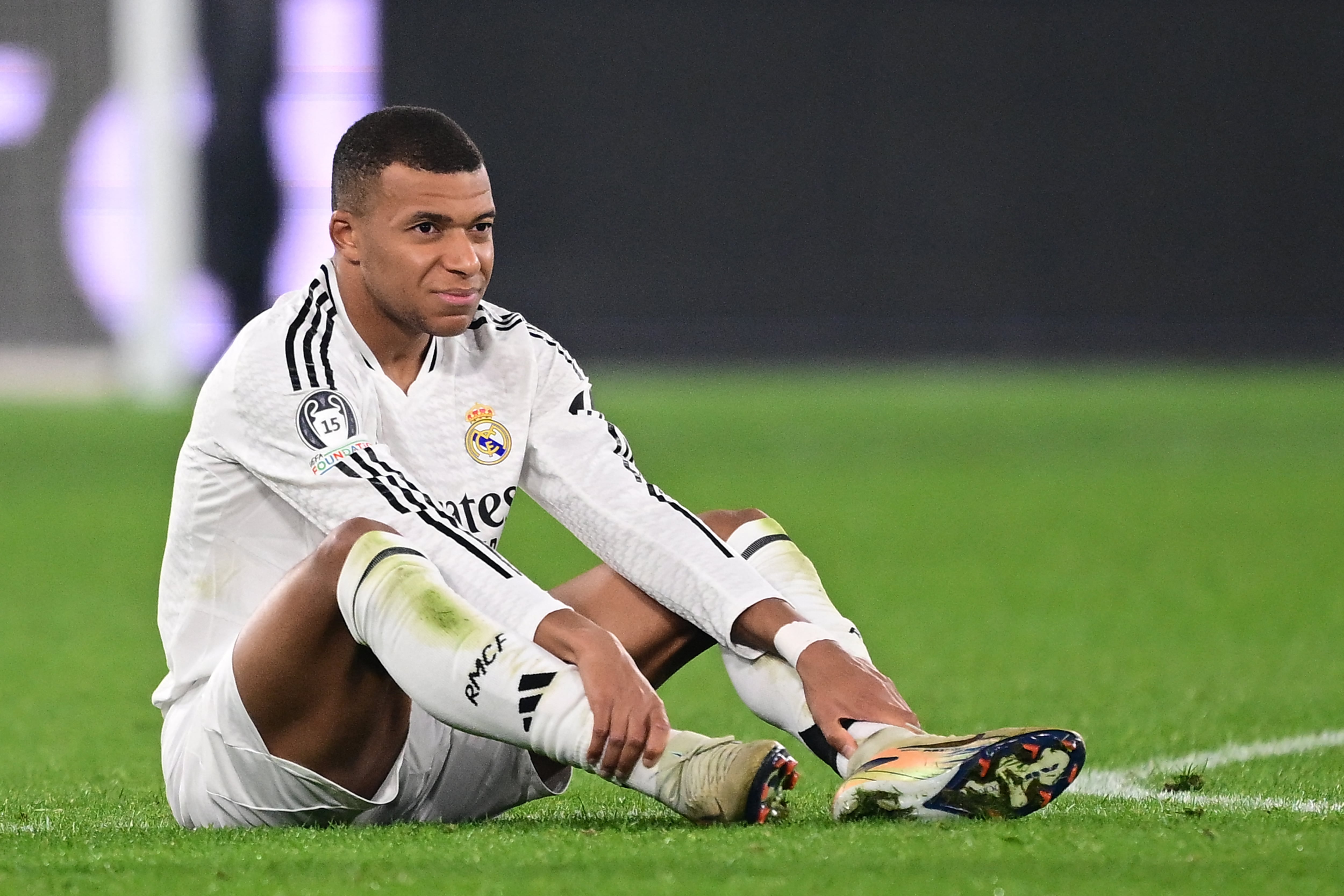 Real Madrid's French forward #09 Kylian Mbappe reacts after an injury during the UEFA Champions League football match between Atalanta and Real Madrid at the Gewiss Stadium in Bergamo, on December 10, 2024. (Photo by Marco BERTORELLO / AFP)