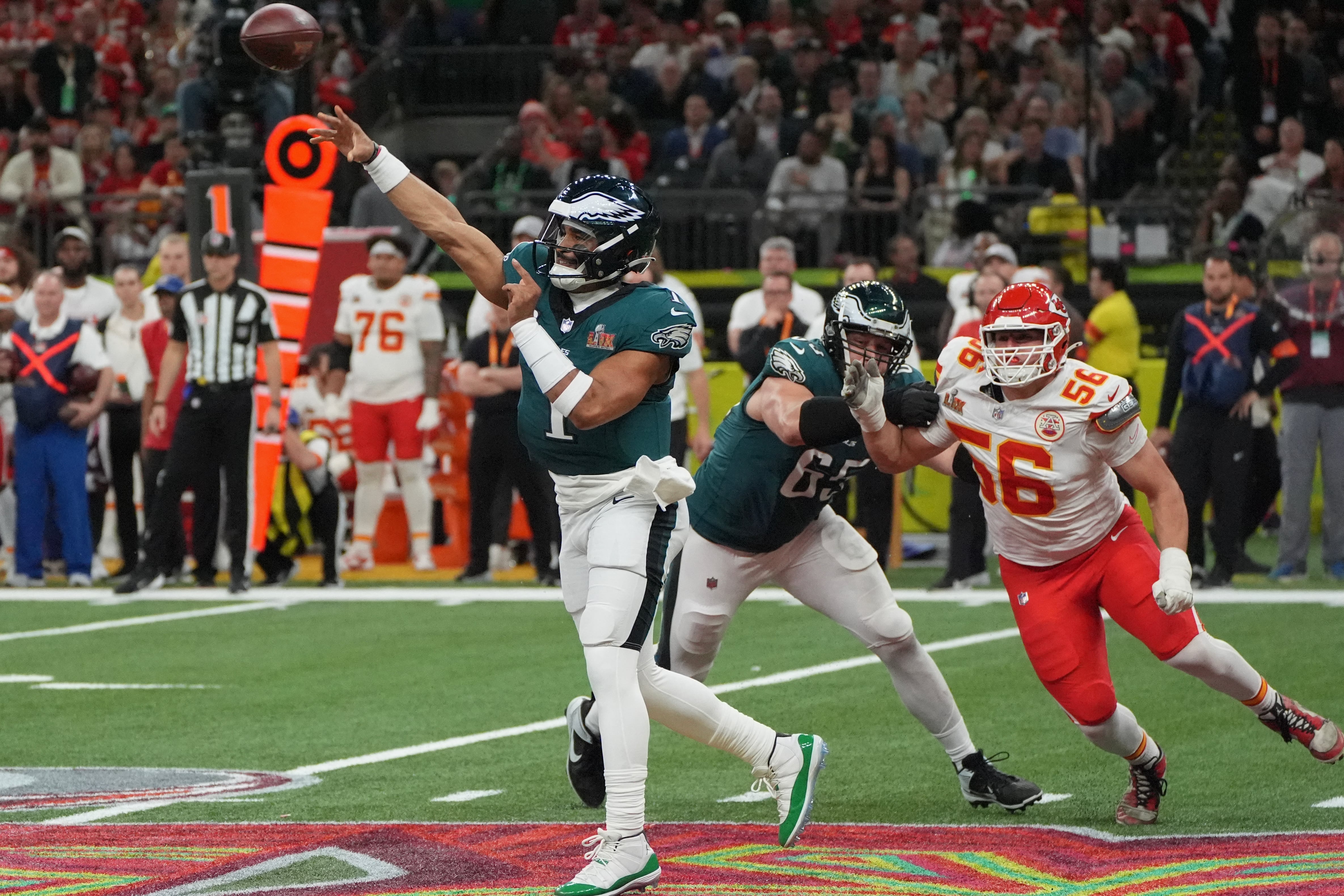 Philadelphia Eagles' quarterback #01 Jalen Hurts throws the ball as he is pursued by Kansas City Chiefs' defensive end #56 George Karlaftis during Super Bowl LIX between the Kansas City Chiefs and the Philadelphia Eagles at Caesars Superdome in New Orleans, Louisiana, February 9, 2025. (Photo by TIMOTHY A. CLARY / AFP)